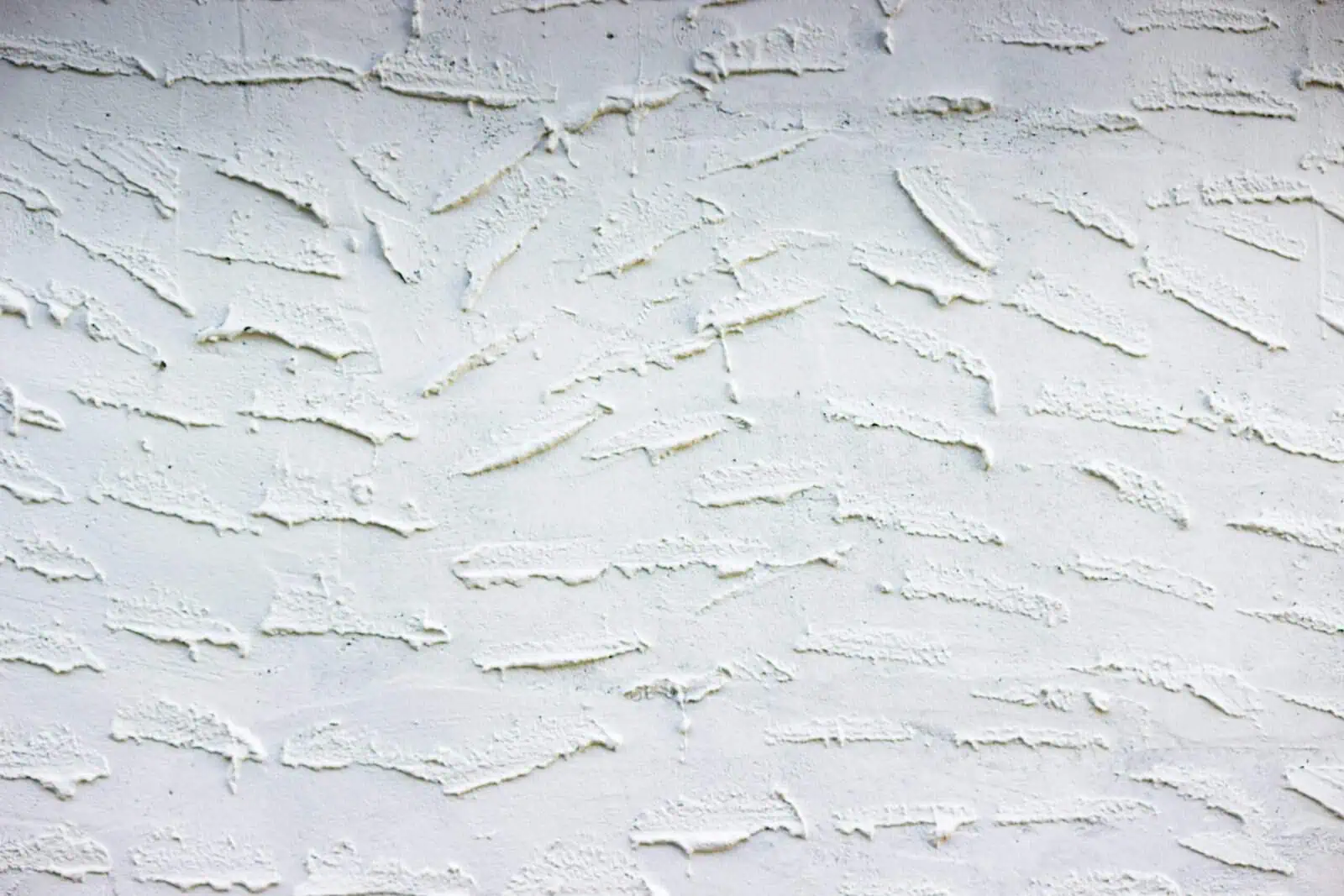 Close-up of textured drywall surface in a residential interior.